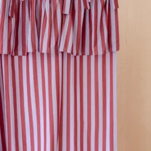 Pair of Cotton Tie-Top Curtains in Lilac Stripe from TBCo hanging with soft lilac and pink stripes on a wooden rail