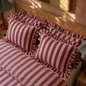 TBCo Cotton Duvet Cover & Pillowcases Set in Pink & Burgundy Stripe styled on rattan bed with soft natural light