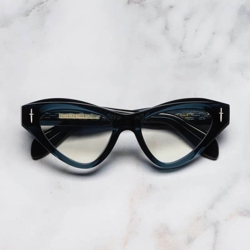 An image of the The Great Frog Mini Cat Eye Optical Glasses in Deep Teal frame frontal view with arms closed marble background