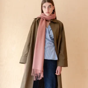 Woman wearing TBCo Lambswool Oversized Scarf in Blush styled with a coat and casual outfit against neutral background