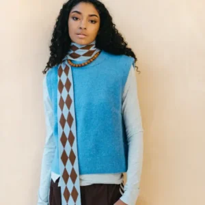 Model wearing TBCo Merino Wool Skinny Scarf in Brown Harlequin with blue and brown diamond pattern wrapped around neck