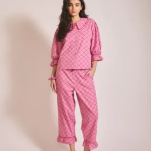 Model wearing TBCo Cropped Cotton Pyjamas in Pink Lattice with frilled cuffs, portrait orientation, gallery image one