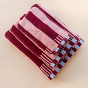 TBCo Cotton Towels in Pink Stripe featuring burgundy stripes and blue checkerboard trim, folded neatly to showcase pattern design